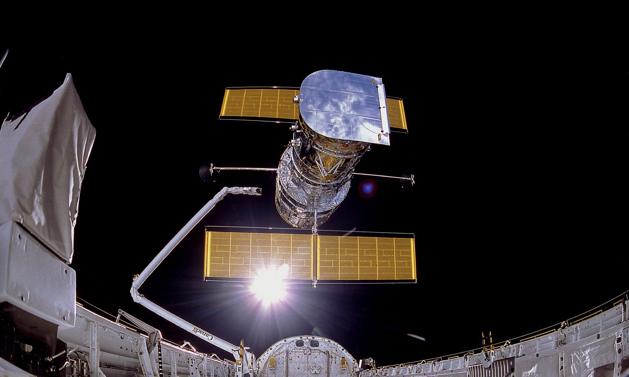 A cropped view of Hubble Space Telescope being deployed from the Space Shuttle in April 1990.